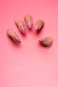 persons hand on pink surface