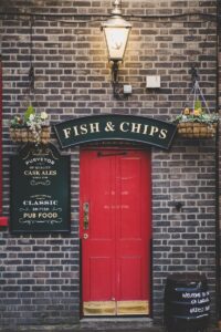 Fish & Chips signage over red door